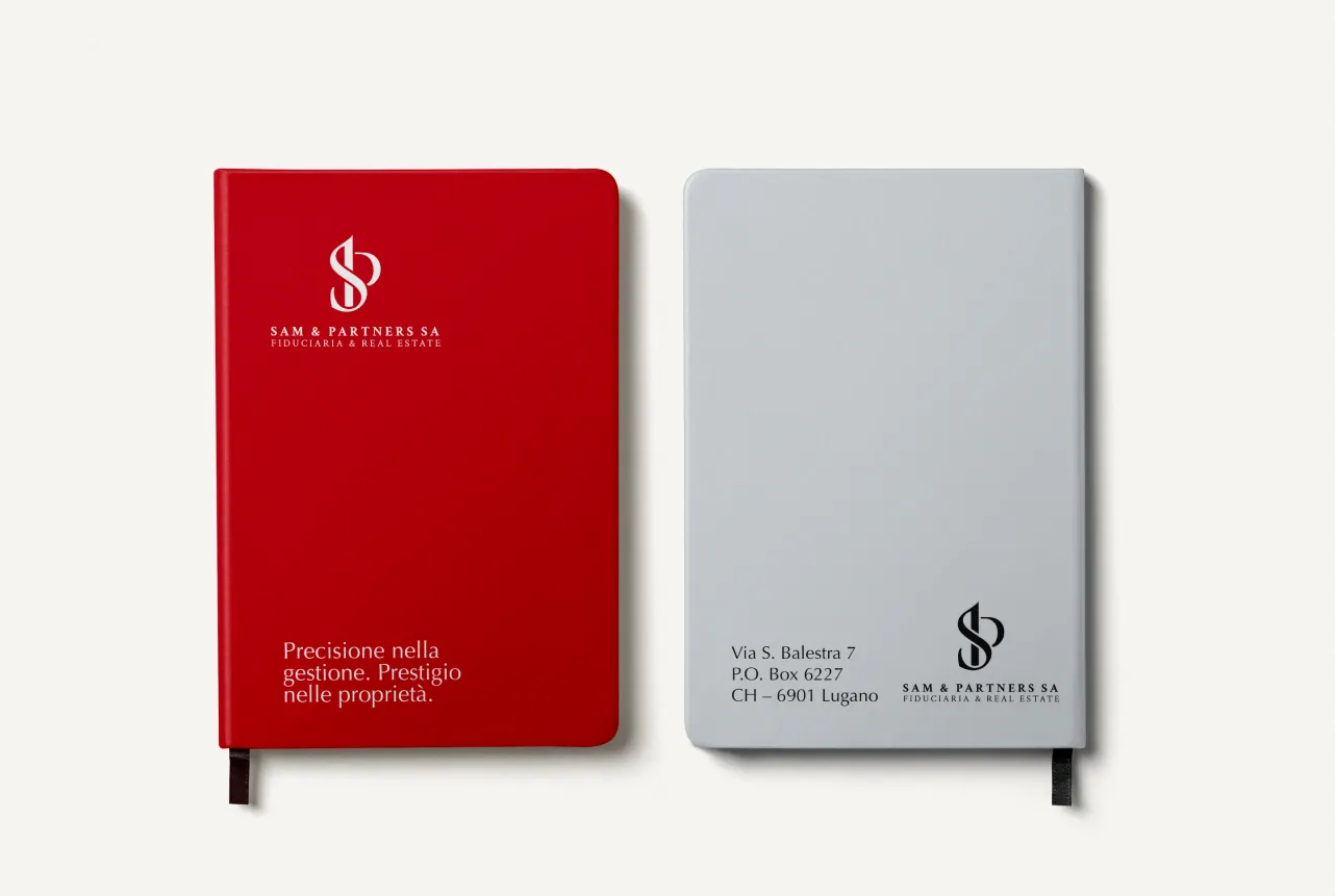 Sam & Partners SA, red and grey notebook with logo and tagline, front and back view