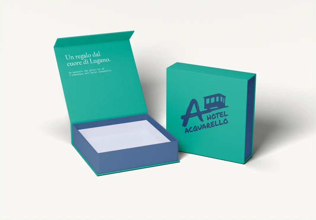 Hotel Acquarello, aqua green gift box with logo and the words "A gift from the heart of Lugano"